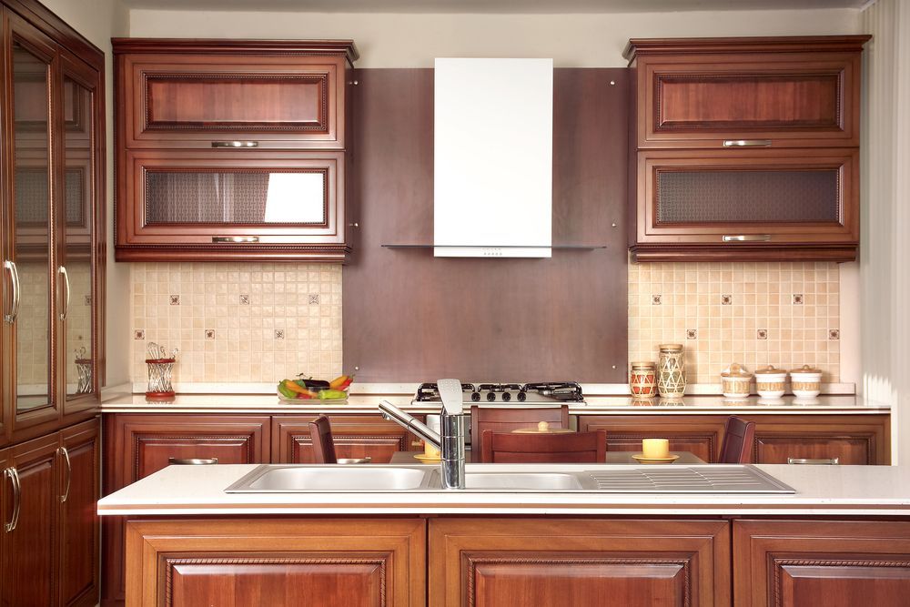 A kitchen with wooden cabinets and a sink