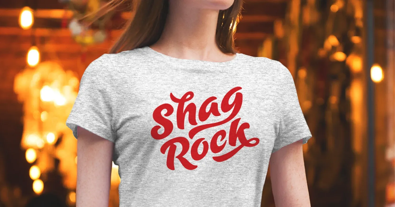 Shag rock logo on a light grey T-Shirt worn by a young woman coming out of a bar