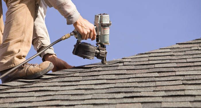 A person repairing roof A person repairing roof
