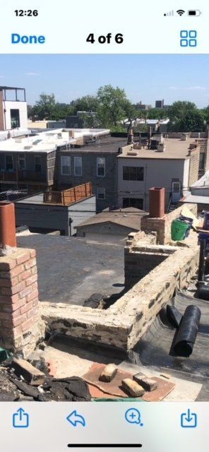 A phone screen shows a picture of the roof of a building