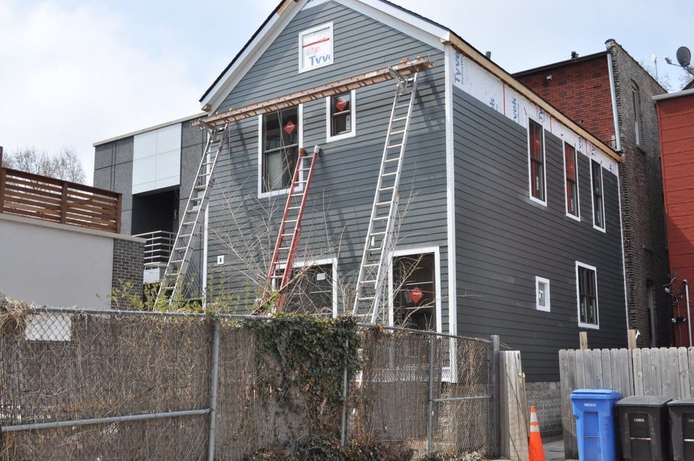 A house under construction with a ladder on the side of it