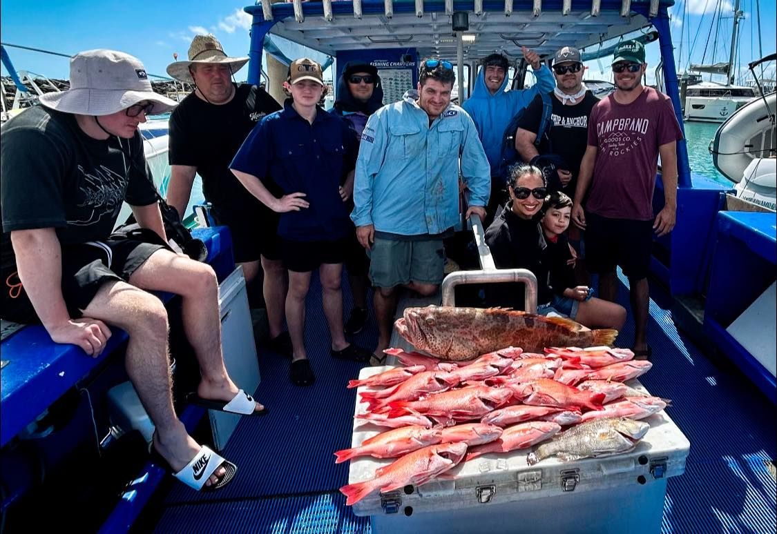 A Group of People Are Posing for a Picture on a Boat — Whitsunday Fishing Charters In Airlie Beach, QLD