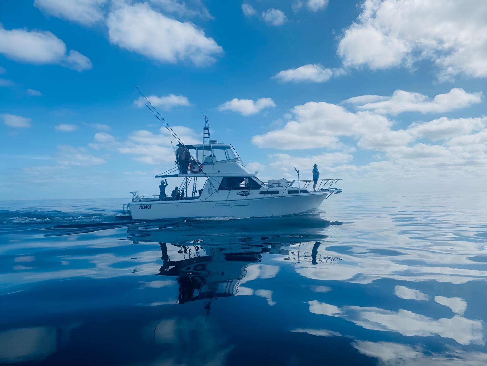 A White Boat Is Floating on Top of A Large Body of Water — Whitsunday Fishing Charters In Airlie Beach, QLD