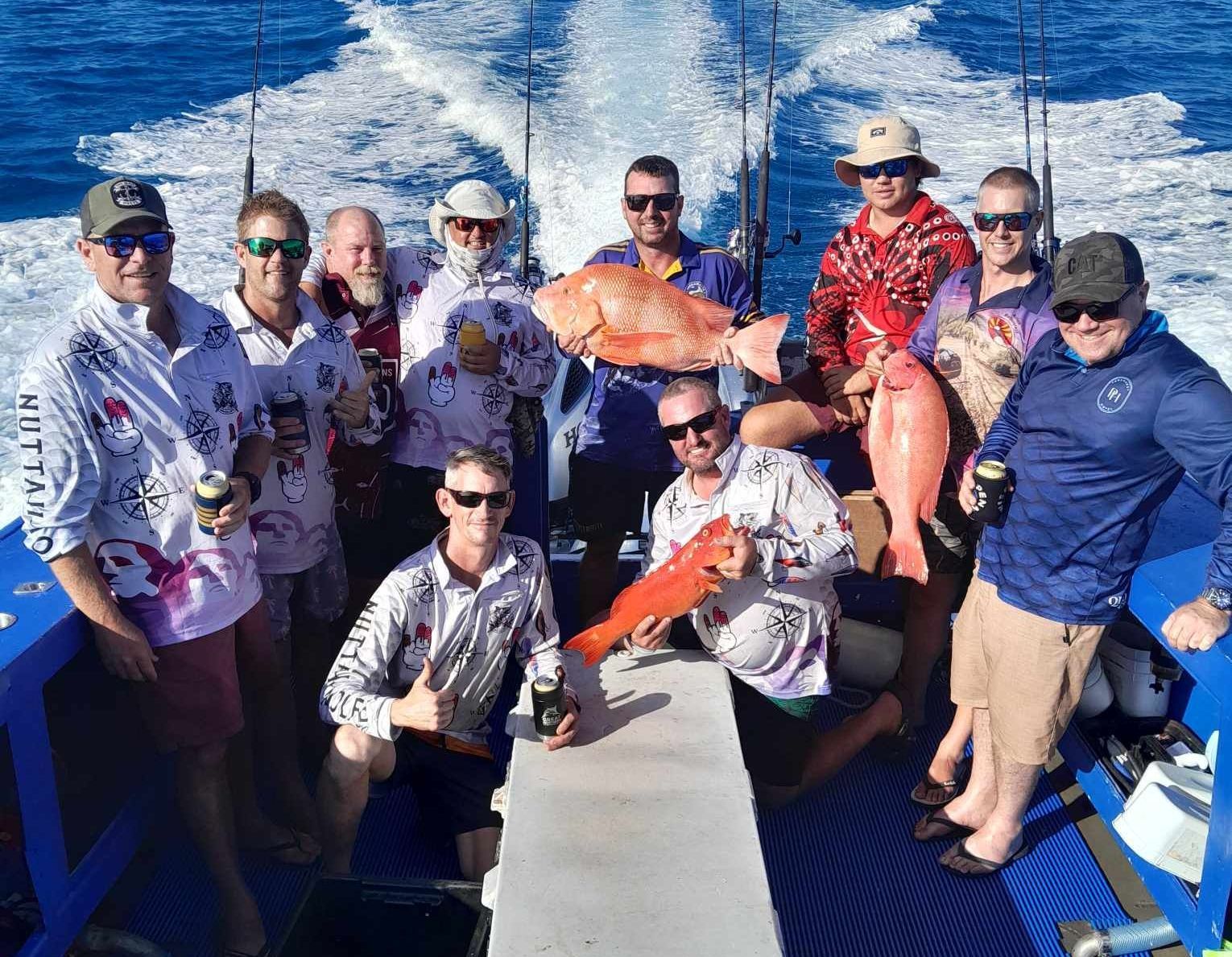 A Cooler Filled With Red Fish is Sitting on a Table — Whitsunday Fishing Charters In Airlie Beach, QLD