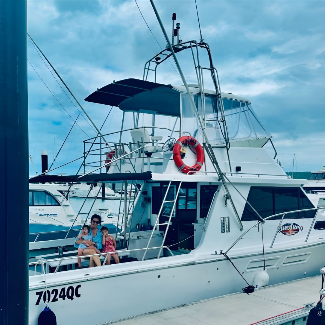 A Family Sitting on The Boat — Whitsunday Fishing Charters In Airlie Beach, QLD