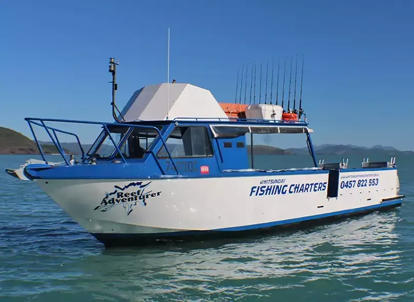 Blue Fishing Boat on Calm Water, with Fishing Rods And Clear Blue Sky  — Whitsunday Fishing Charters In Airlie Beach, QLD