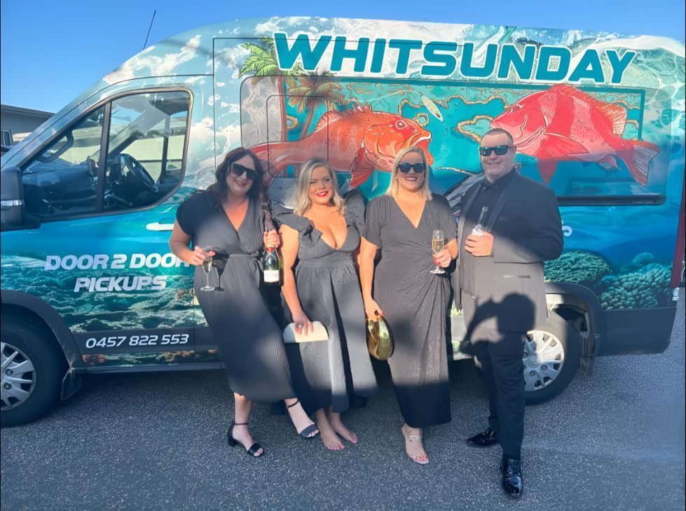 A Group of People Standing in Front of a White Sunday Van — Whitsunday Fishing Charters In Airlie Beach, QLD