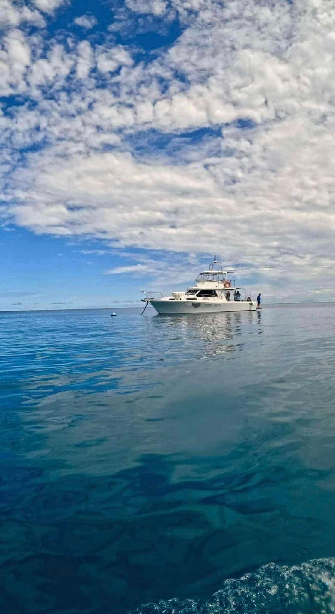 A Boat is Floating on Top of a Large Body of Water — Whitsunday Fishing Charters In Airlie Beach, QLD