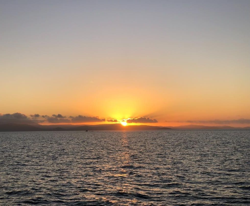 A Sunset Over a Large Body of Water       — Whitsunday Fishing Charters In Airlie Beach, QLD