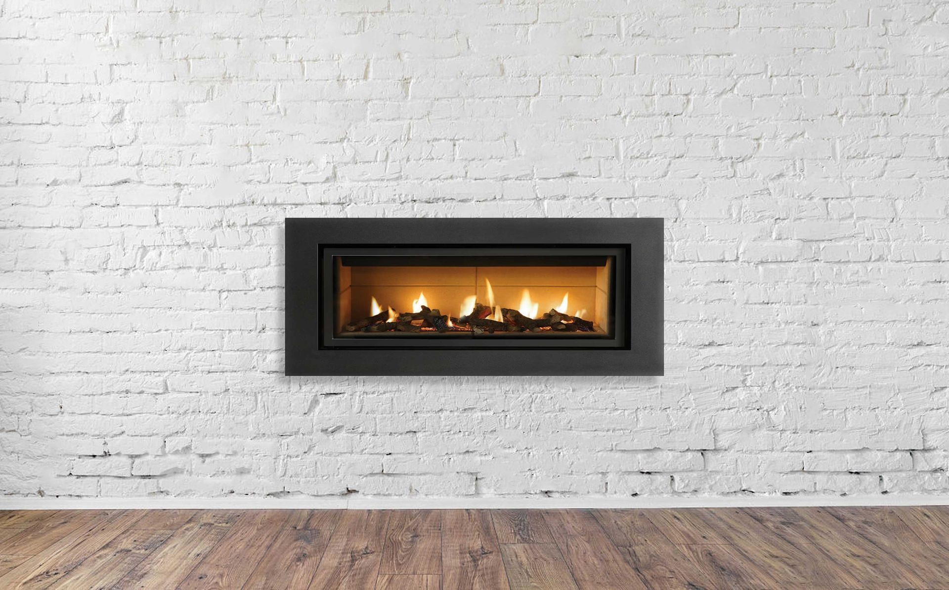 A fireplace is hanging on a white brick wall in an empty room.