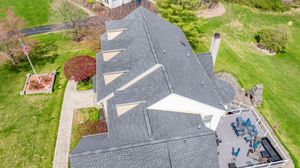 An aerial view of a house with a gray roof.