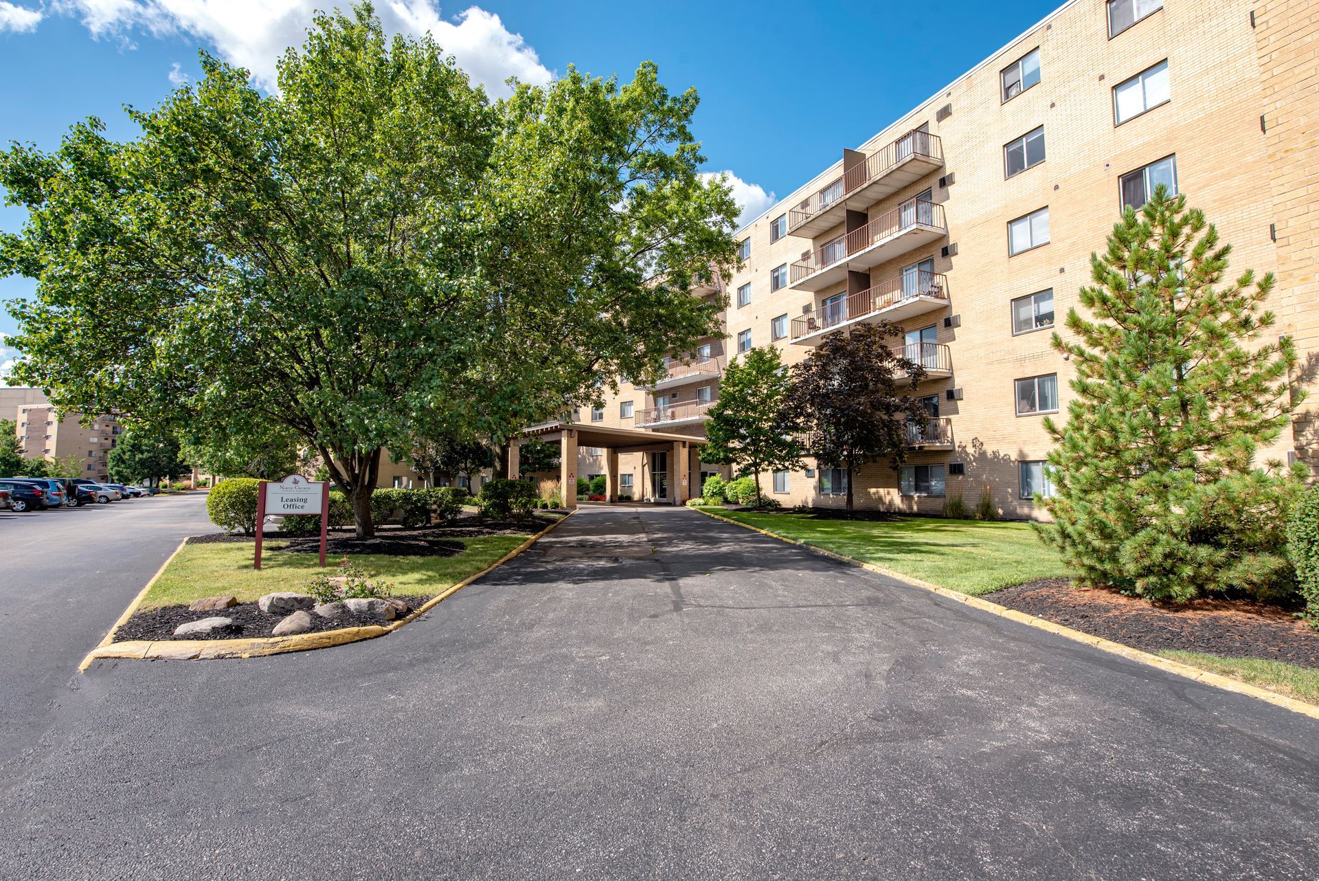 A building with a lot of windows and trees in front of it