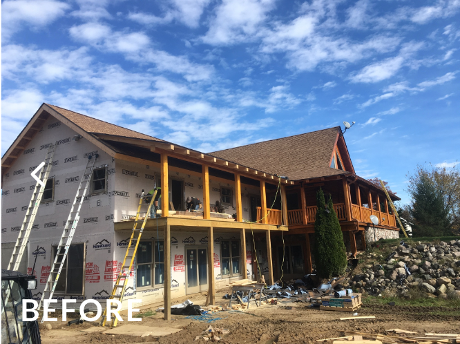 A large house is being built with a lot of windows and a roof.