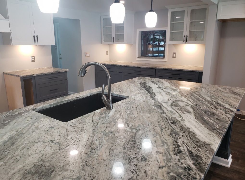 A kitchen with granite counter tops and a sink.