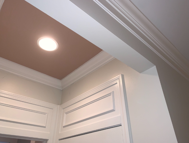 Looking up at the ceiling of a room with white trim