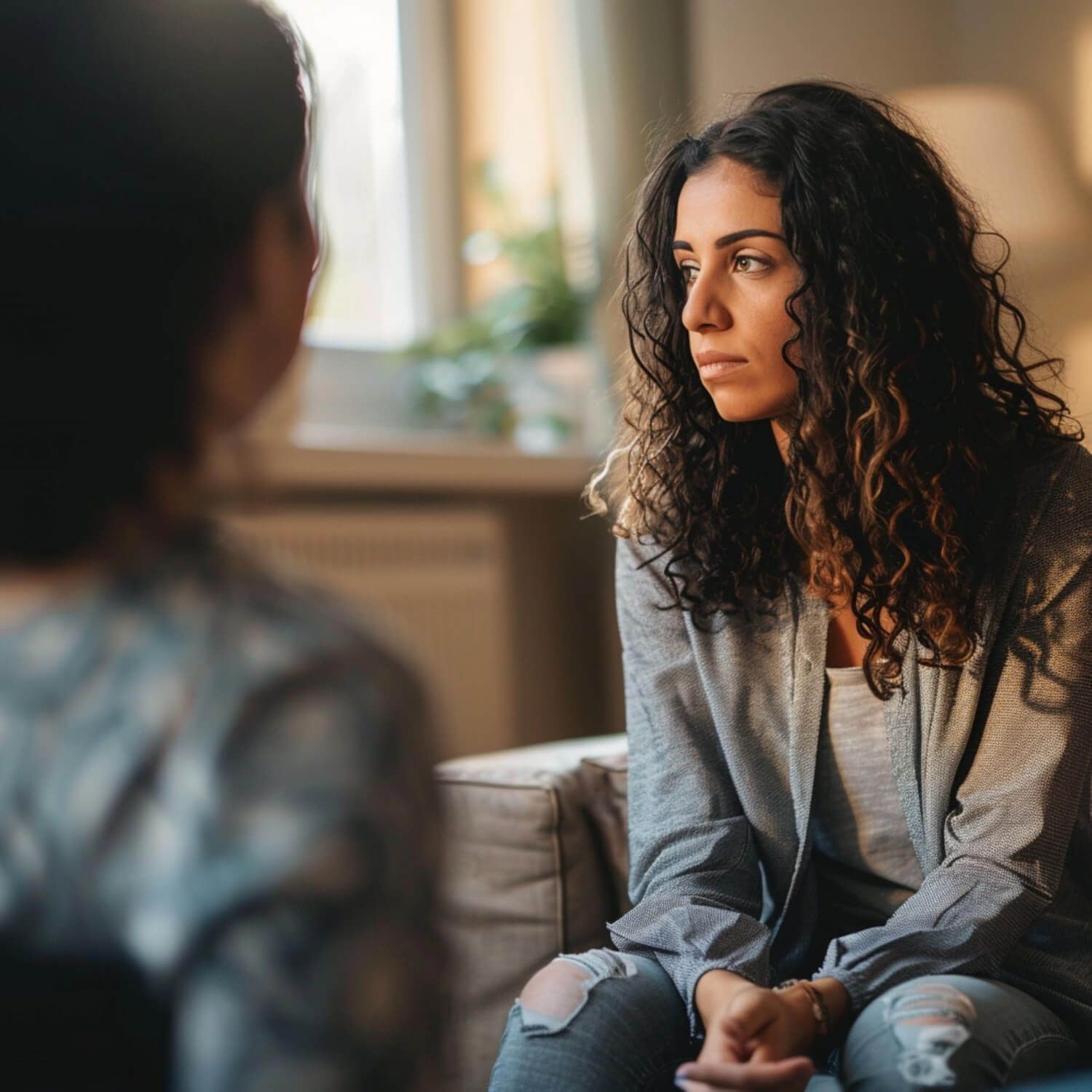 Woman in therapy session discussing complex trauma treatment with therapist, representing the importance of therapeutic relationships in CPTSD recovery