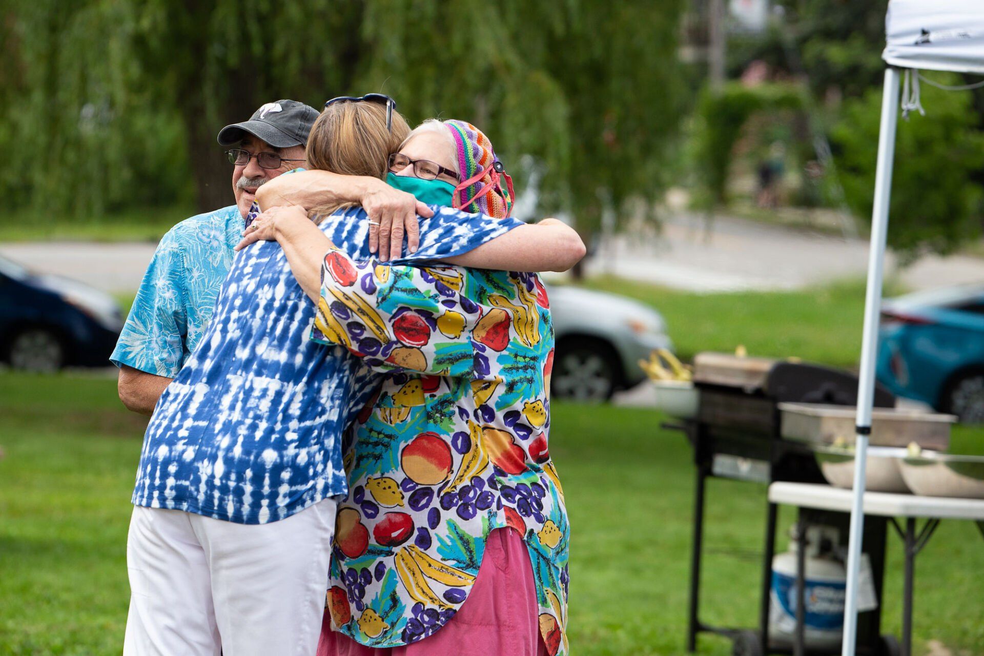 Photo of adults hugging outdoors