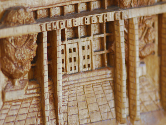 A wood etching of Temple Beth El's front doors
