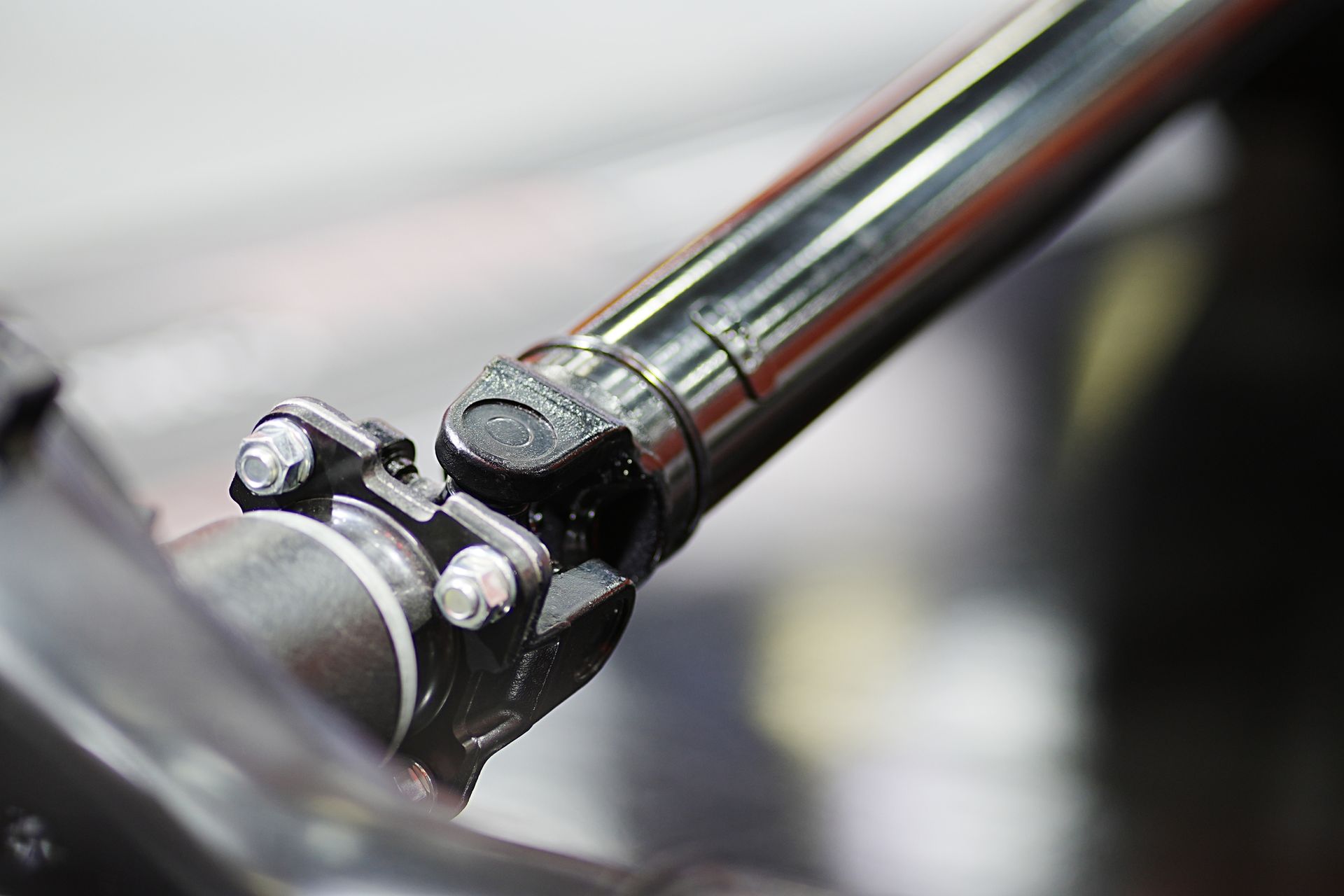 A close up of a drive shaft on a car.