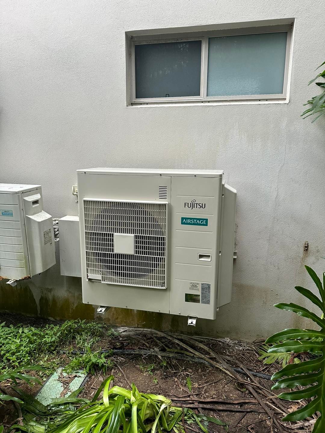 Air Conditioning Unit on a White Stucco Wall — DJL Refrigeration & Air Conditioning In Bowen, QLD