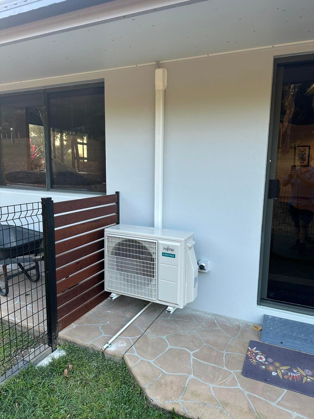 Air Conditioning Unit Mounted on a Light Gray Wall — DJL Refrigeration & Air Conditioning In Cannonvale, QLD