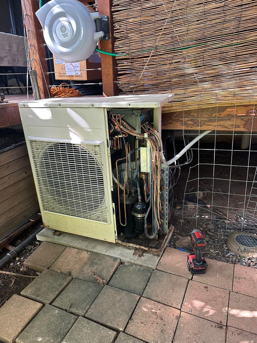 an Open Air Conditioner With Exposed Copper Pipes — DJL Refrigeration & Air Conditioning In Proserpine, QLD