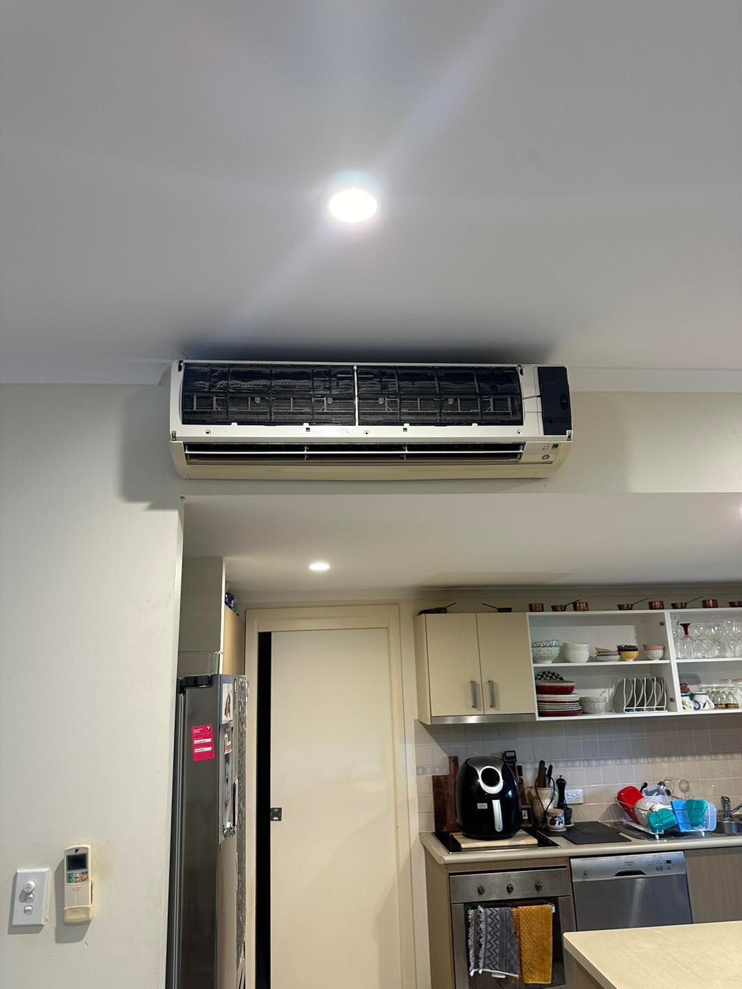 Air conditioning unit mounted on a ceiling above a kitchen — DJL Refrigeration & Air Conditioning In Cannonvale, QLD