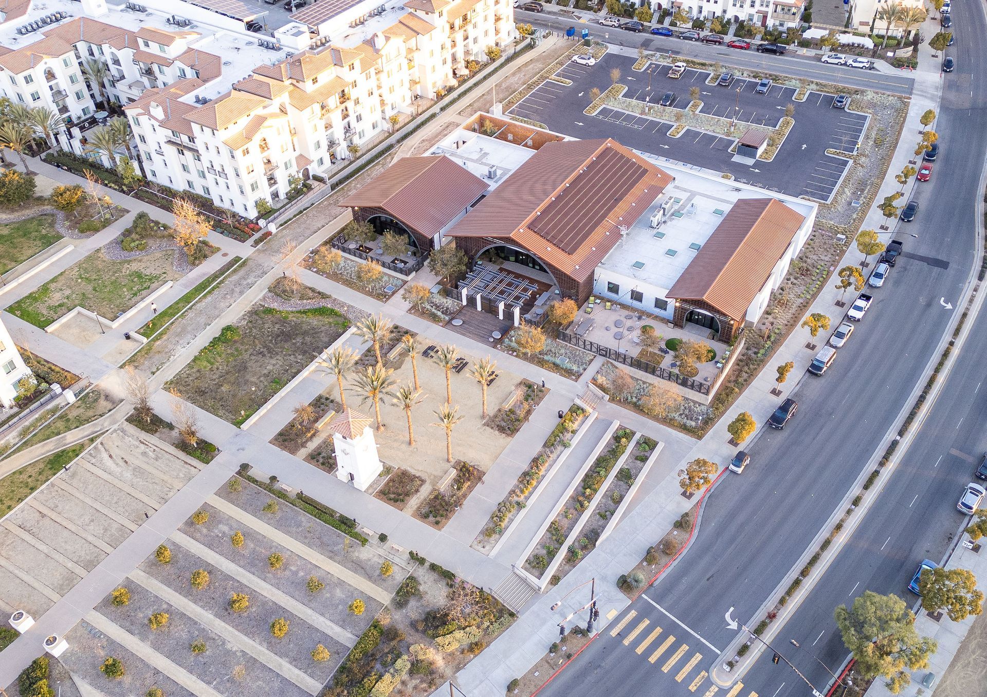 An aerial view of a city with lots of buildings and parking lots
