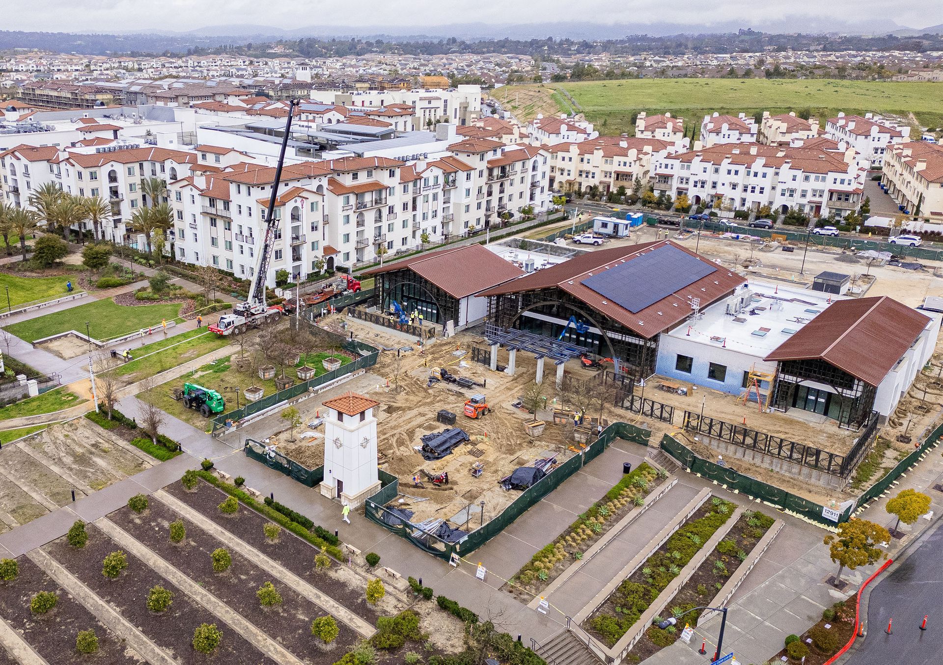 An aerial view of a building under construction in a city.