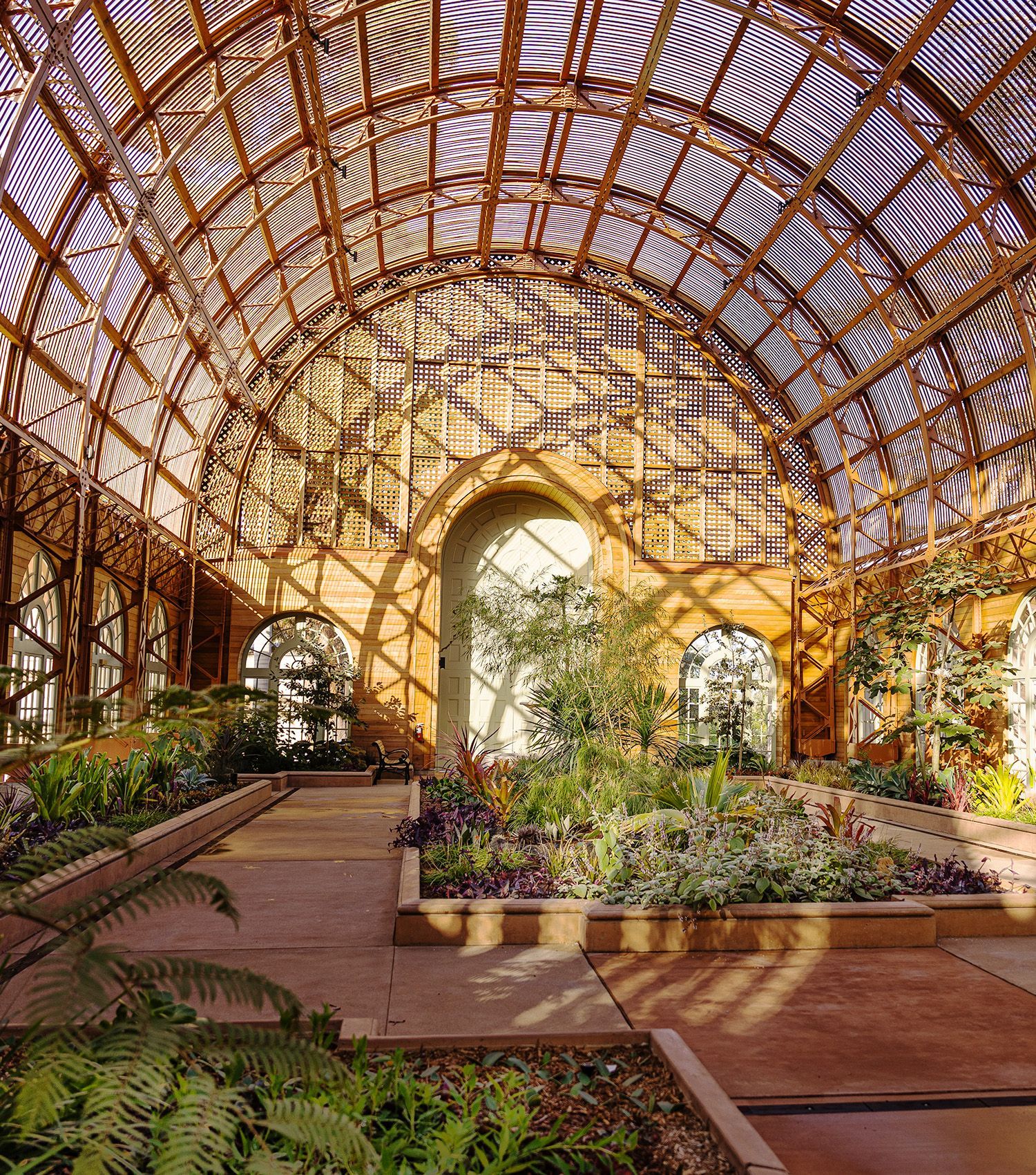 A large greenhouse filled with lots of plants and flowers. San Diego Balboa Park botanical building.