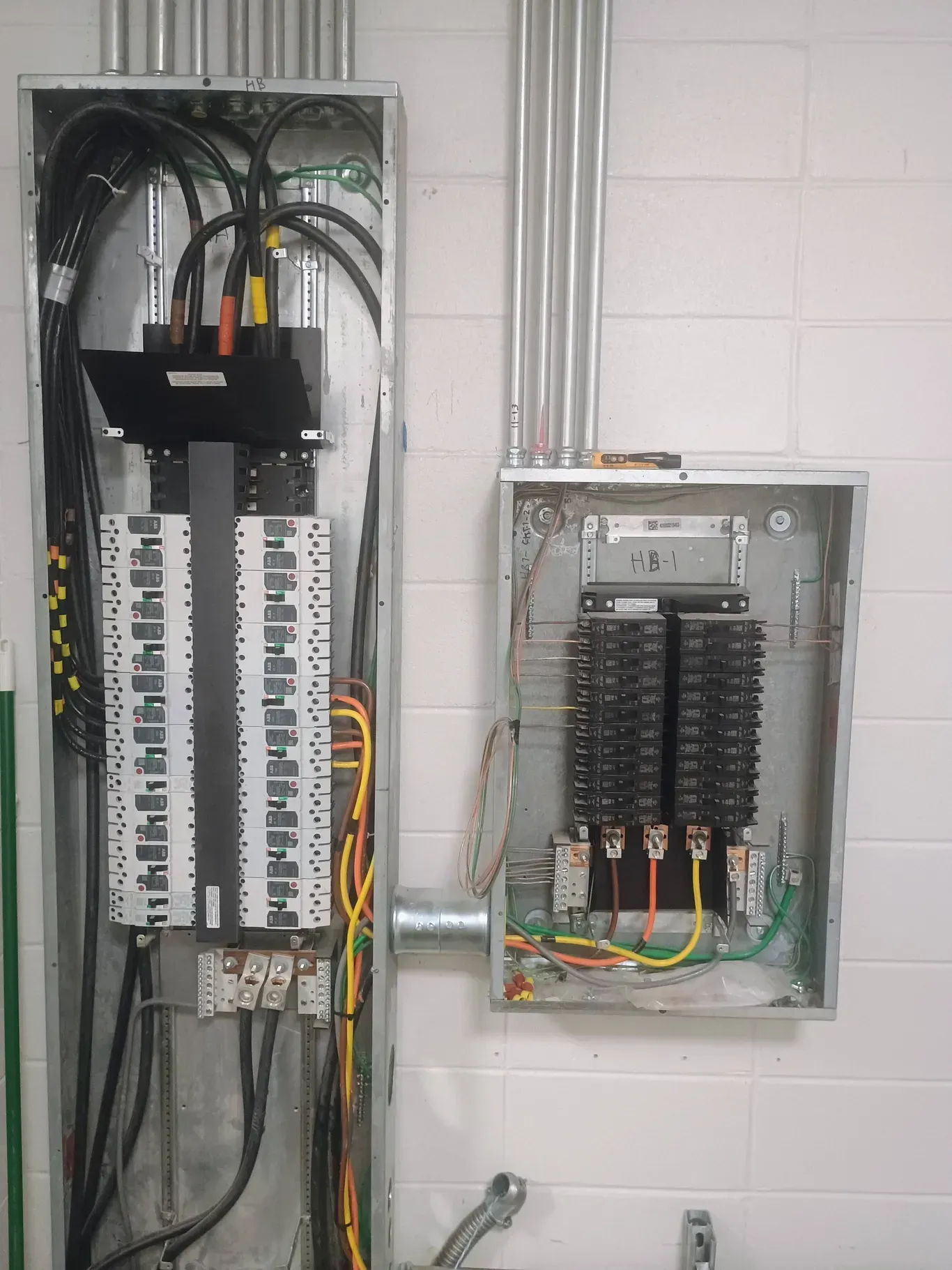Electrical panel with wires and circuit breakers.