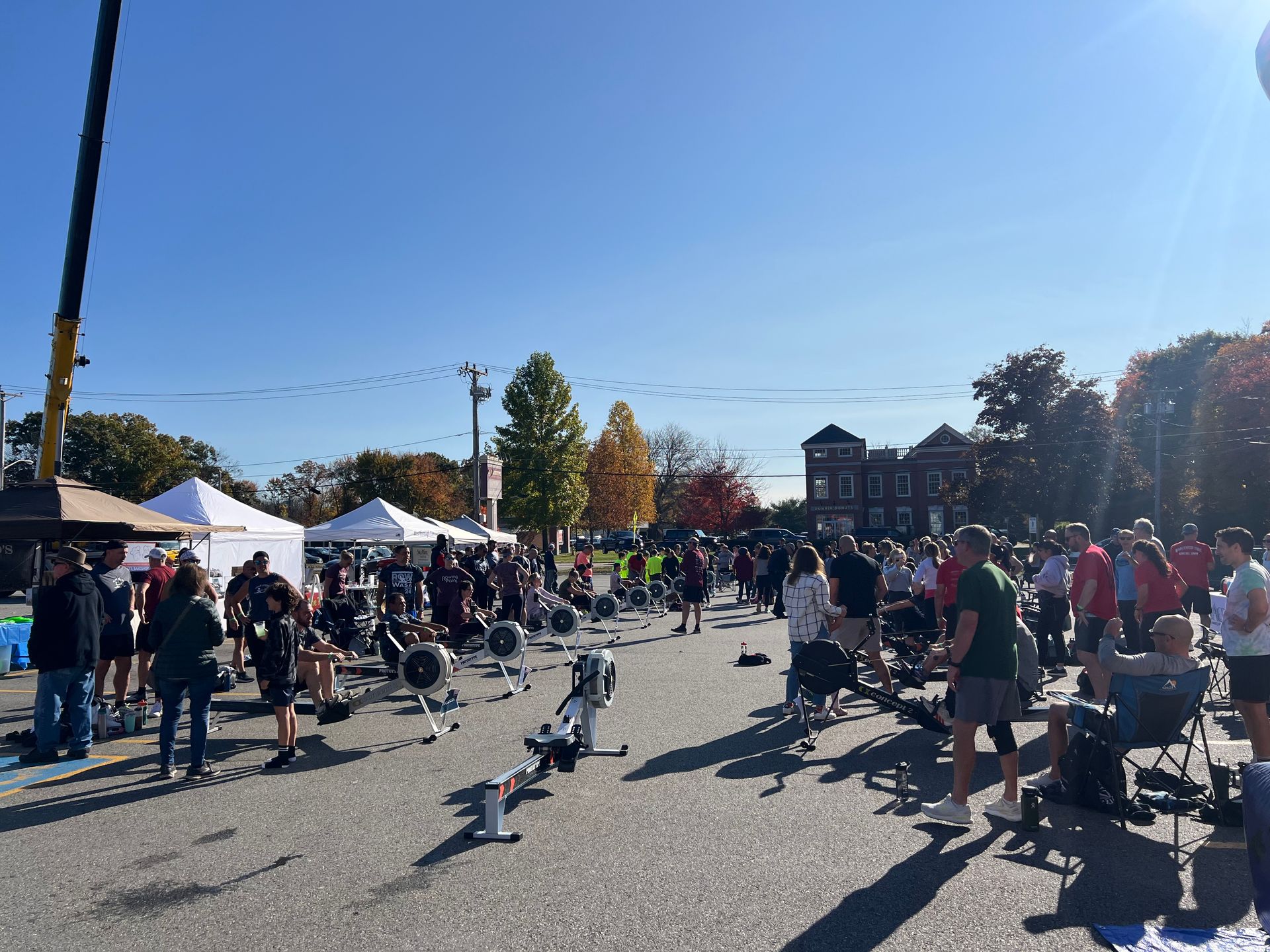 A group of people are standing in a parking lot with their hands in the air.