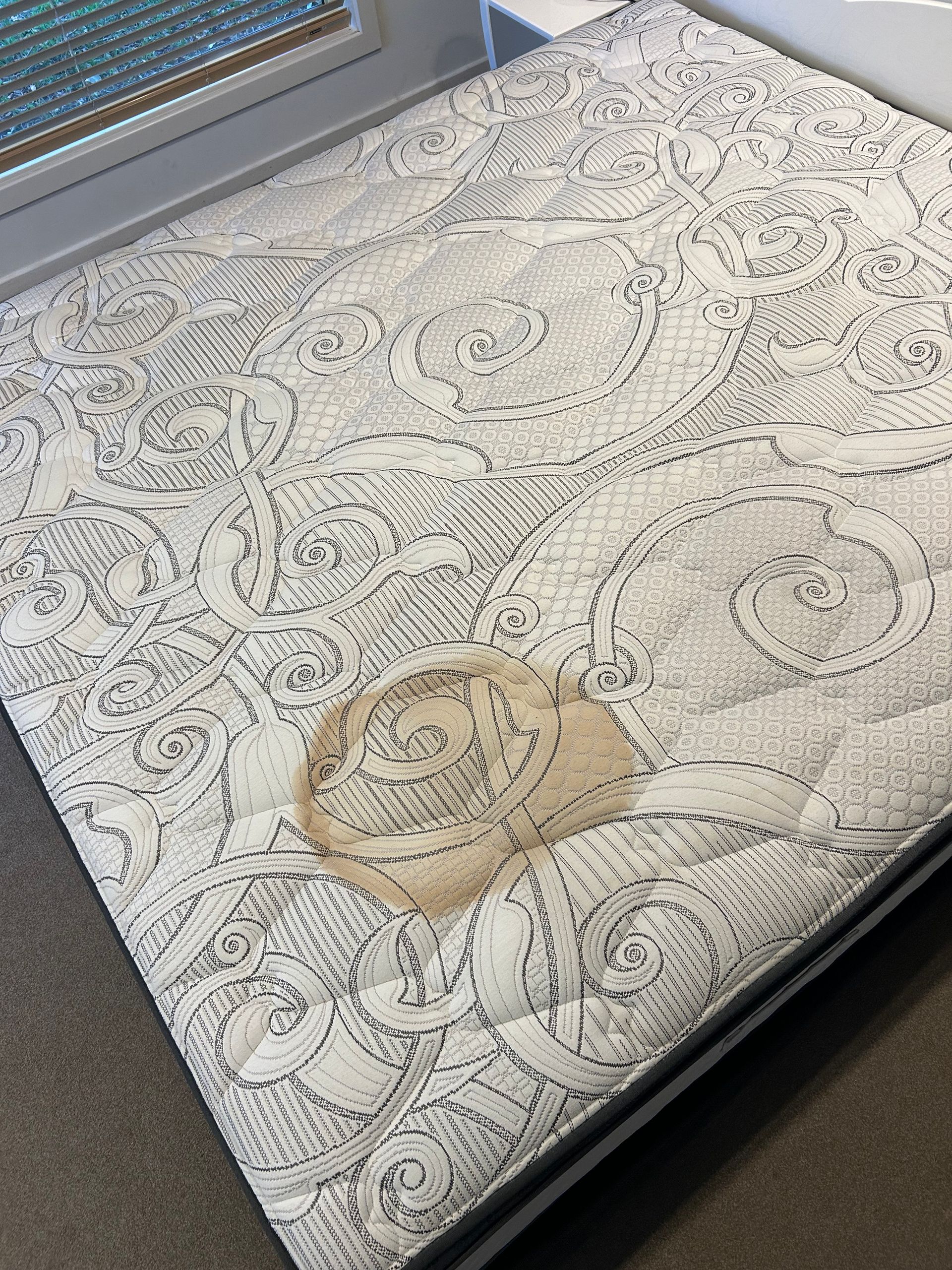 A Person is Cleaning a Mattress With a Steam Cleaner — Rugrats Carpet Cleaning Service In Charlotte Bay, NSW