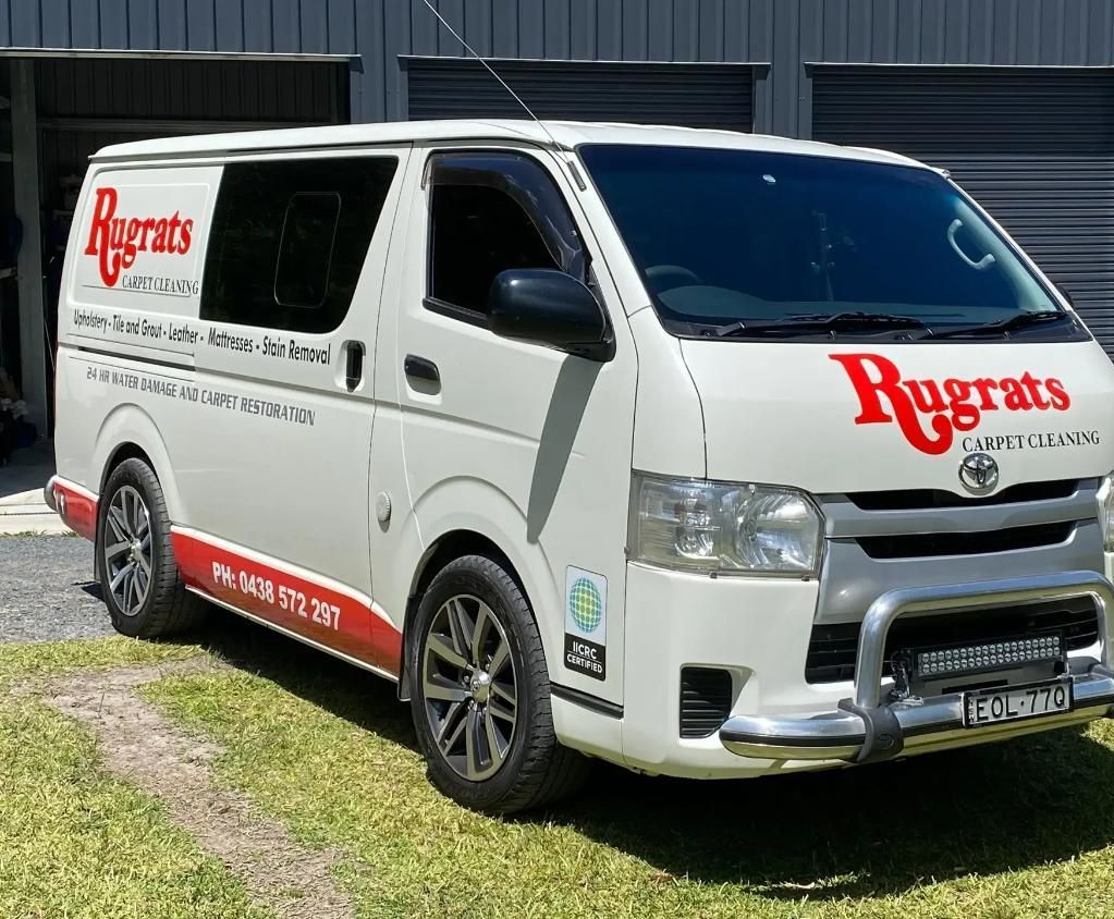 A Vacuum Cleaner is Being Used to Clean a Carpet — Rugrats Carpet Cleaning Service In Tuncurry, NSW