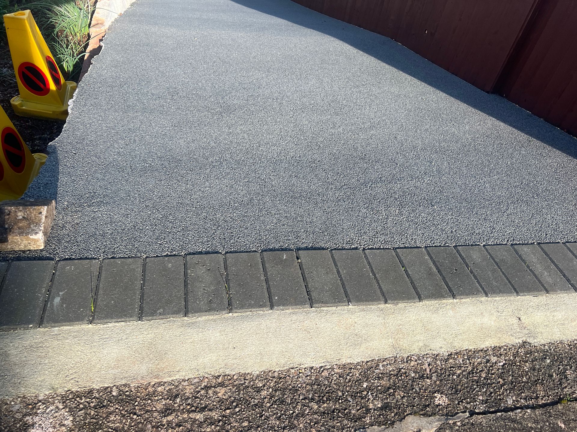 Grey resin driveway with grey block paving border