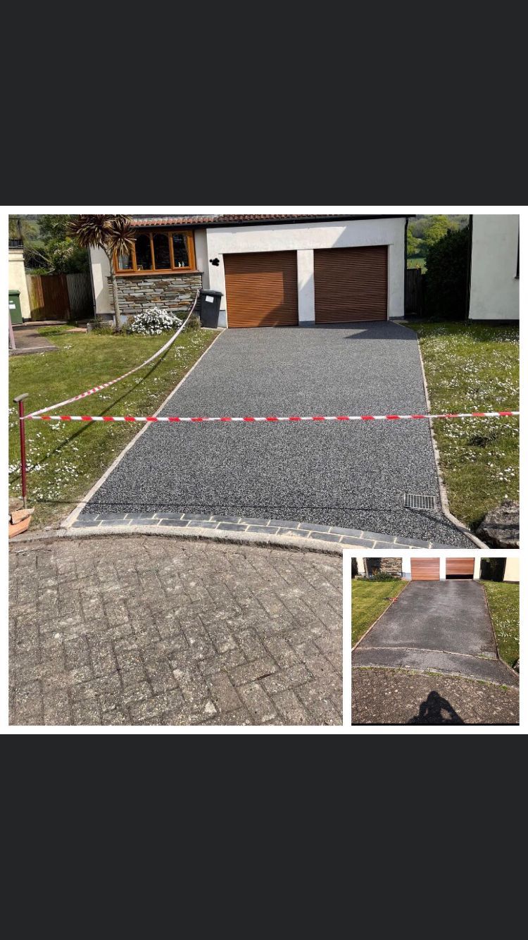 Grey resin driveway taped off, in front of 2 garages with wooden doors.