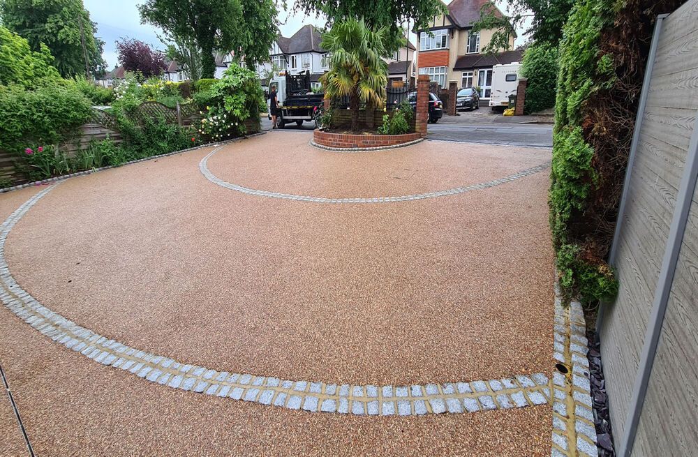 Brown resin driveway with grey block paving accents.