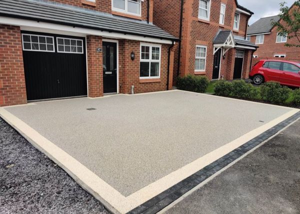 Resin driveway in Bristol with black blocks at the end.