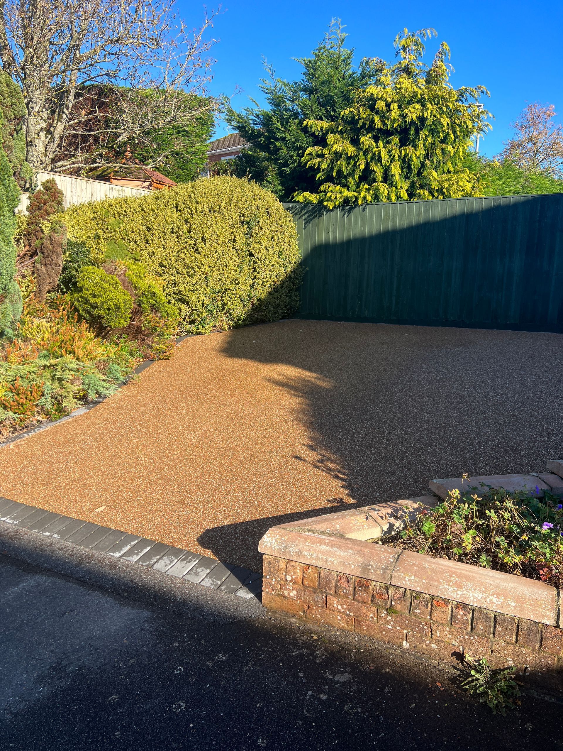 Resin bound driveway with blocks around the edges.