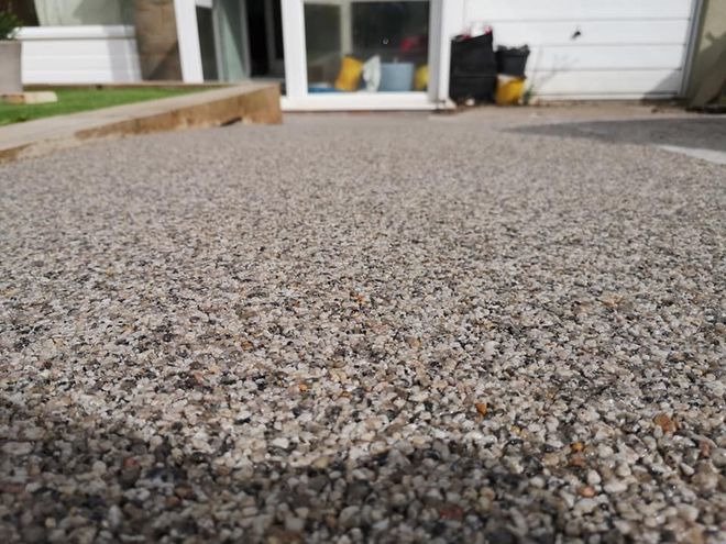 Resin driveway installation near Bristol, with light and dark aggregates mixed together.