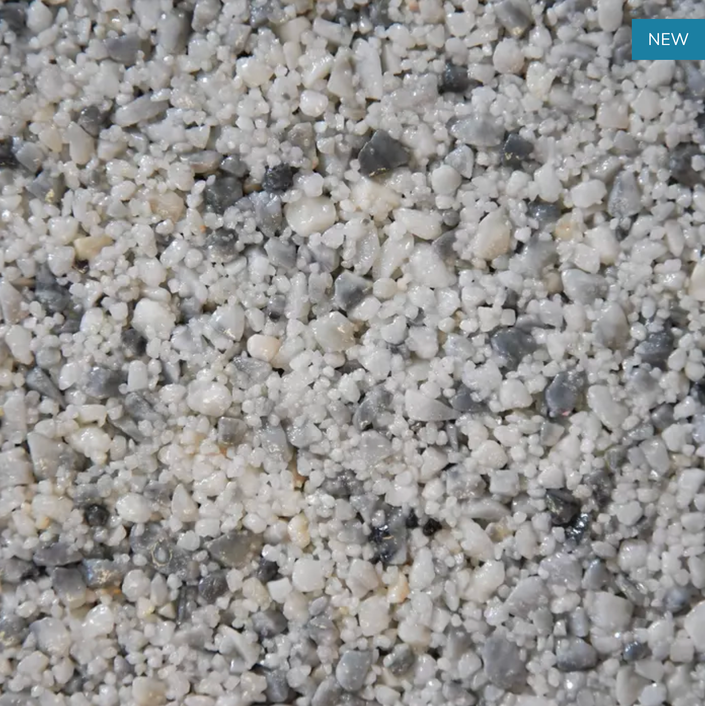 Close-up of a speckled aggregate with varying sizes of white and gray stone chips.