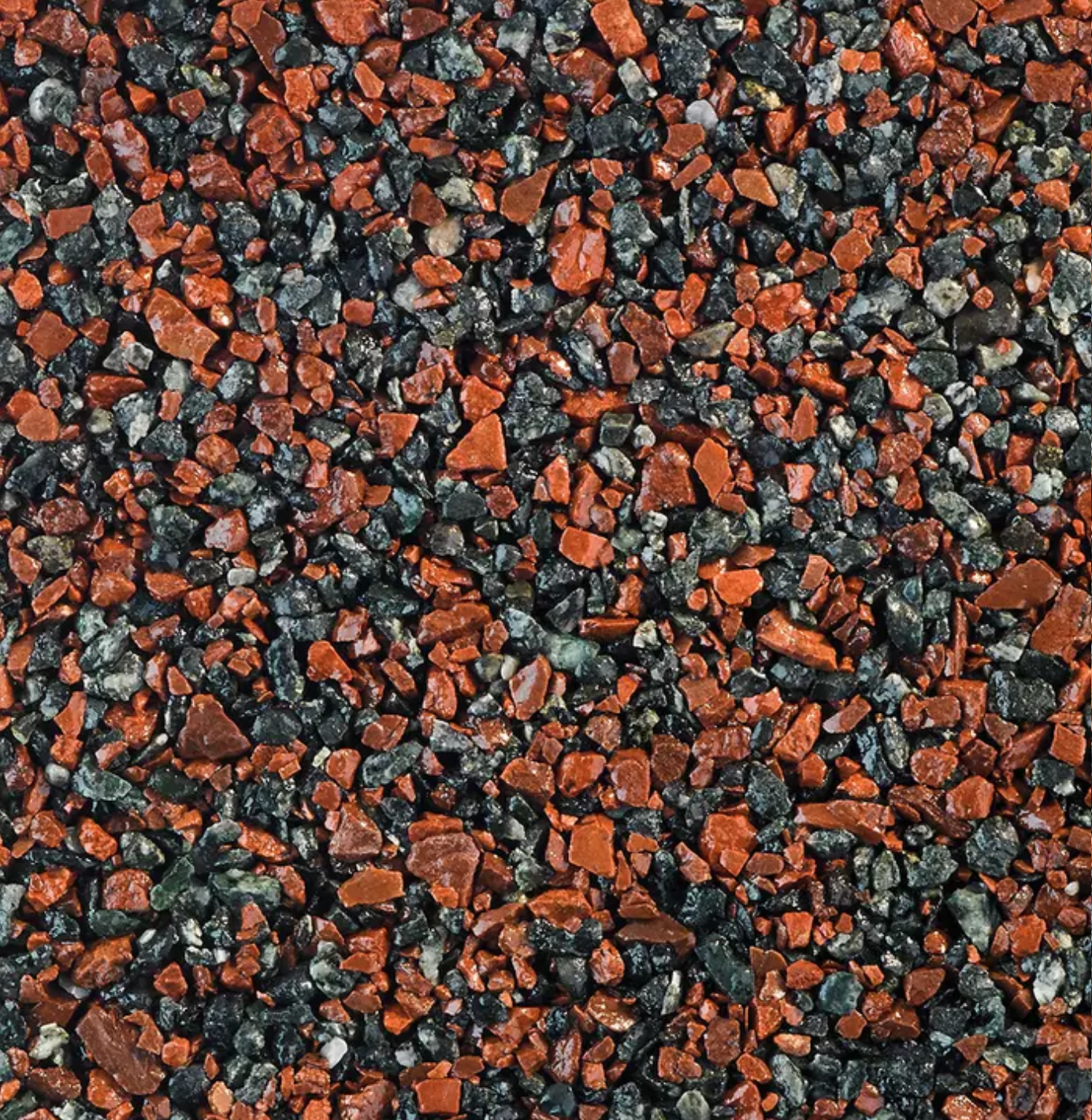 Close-up of gravel; mixture of dark grey and reddish-brown stones.