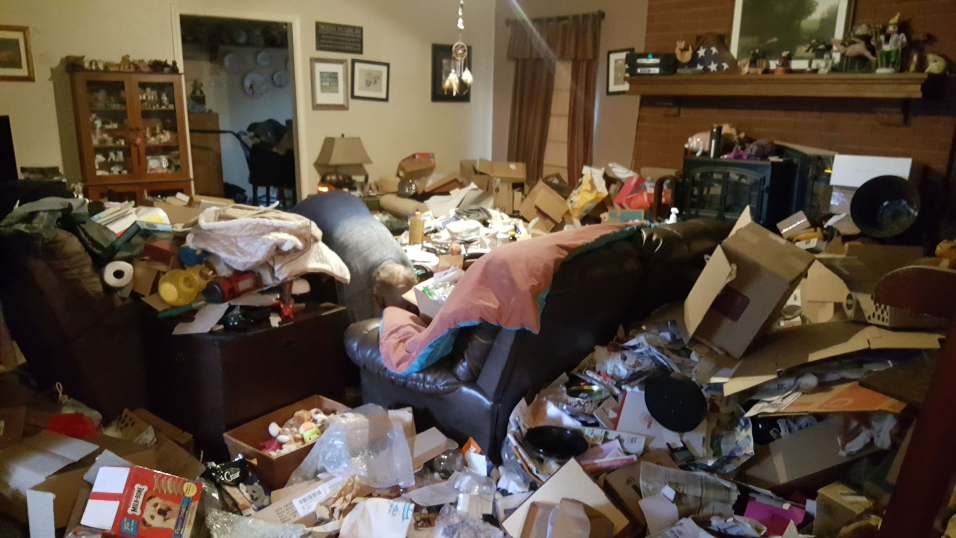 A living room with a white couch and two coffee tables.