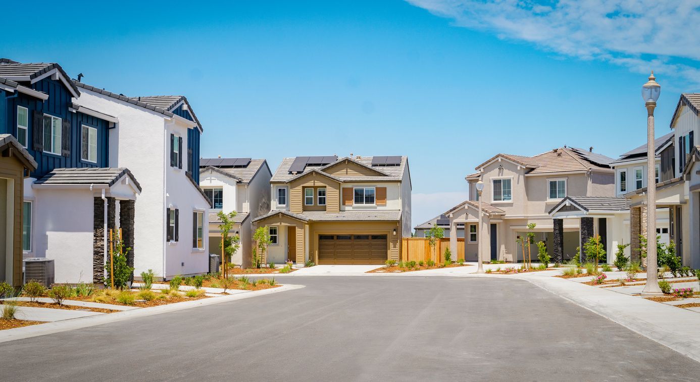 A row of houses in a residential neighborhood on a sunny day.