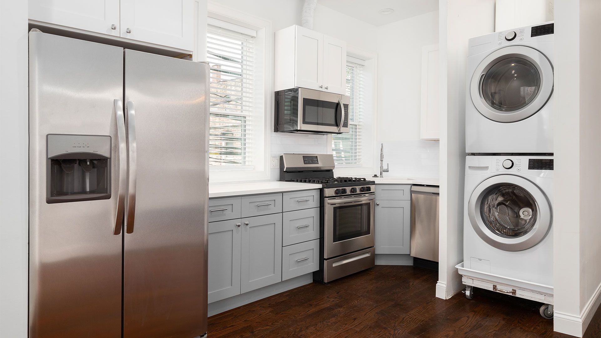 A kitchen with stainless steel appliances and white cabinets.