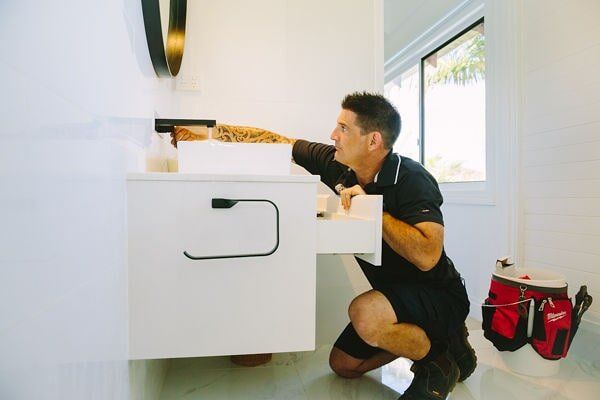 Plumber fixing a toilet — Emergency plumber in Tugun, QLD