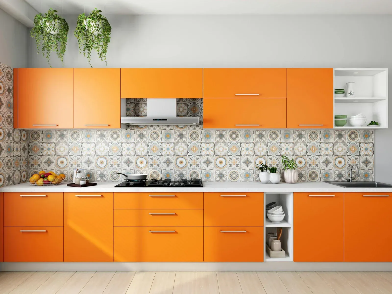 Orange kitchen cabinets with patterned backsplash, stainless steel appliances, and hanging plants.