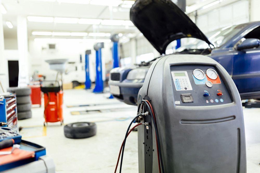 A Machine Is Sitting In A Garage With A Car — Ag Auto Spark in Warren, NSW