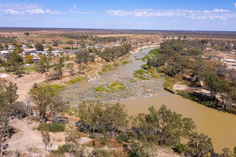 An Aerial View Of A River Surrounded By Trees And Houses — Ag Auto Spark in Brewarrina, NSW