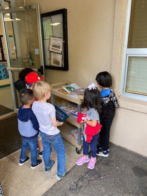 Head Start pre-k students picking out books